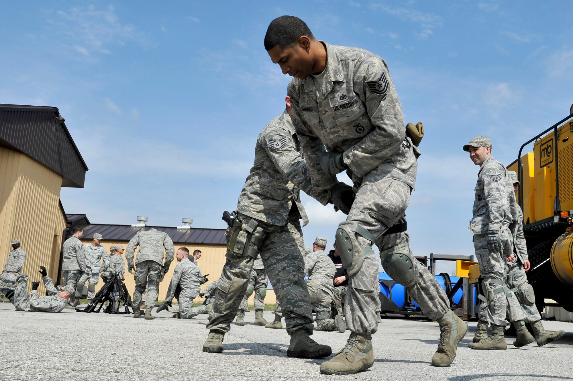 Security Forces Squadron trainers practice defense strategies during Progressive Combat Solutions training at Scott Air Force Base, Ill., April 8, 2014. The Progressive Combat Solutions trains military and law enforcement personnel in decision making process originally benchmarked by the Air Force known as observe, orient, decide and act. The Air Mobility Command and the 375th Security Force Squadron hosted this training with the goal of implementing it across the AMC command in the future. (U.S. Air Force photo/ Airman 1st Class Kiana Brothers)