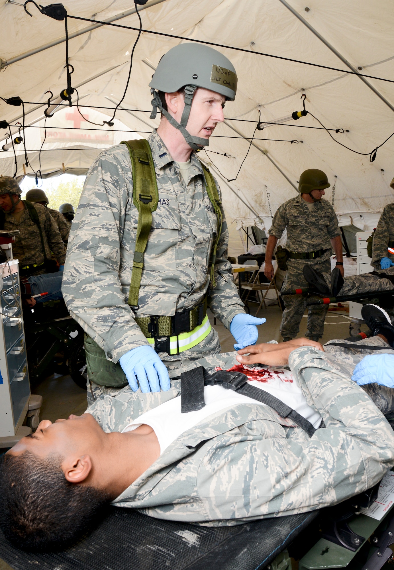 Members of the 147th Reconnaissance Wing Medical Group treat a simulated victim of a mass casualty event during an Operational Readiness Exercise April 4, 2014 at Ellington Field Joint Reserve Base, Houston, TX. The scenario tested the Medical Group's readiness and efficiency to respond to a real world event.