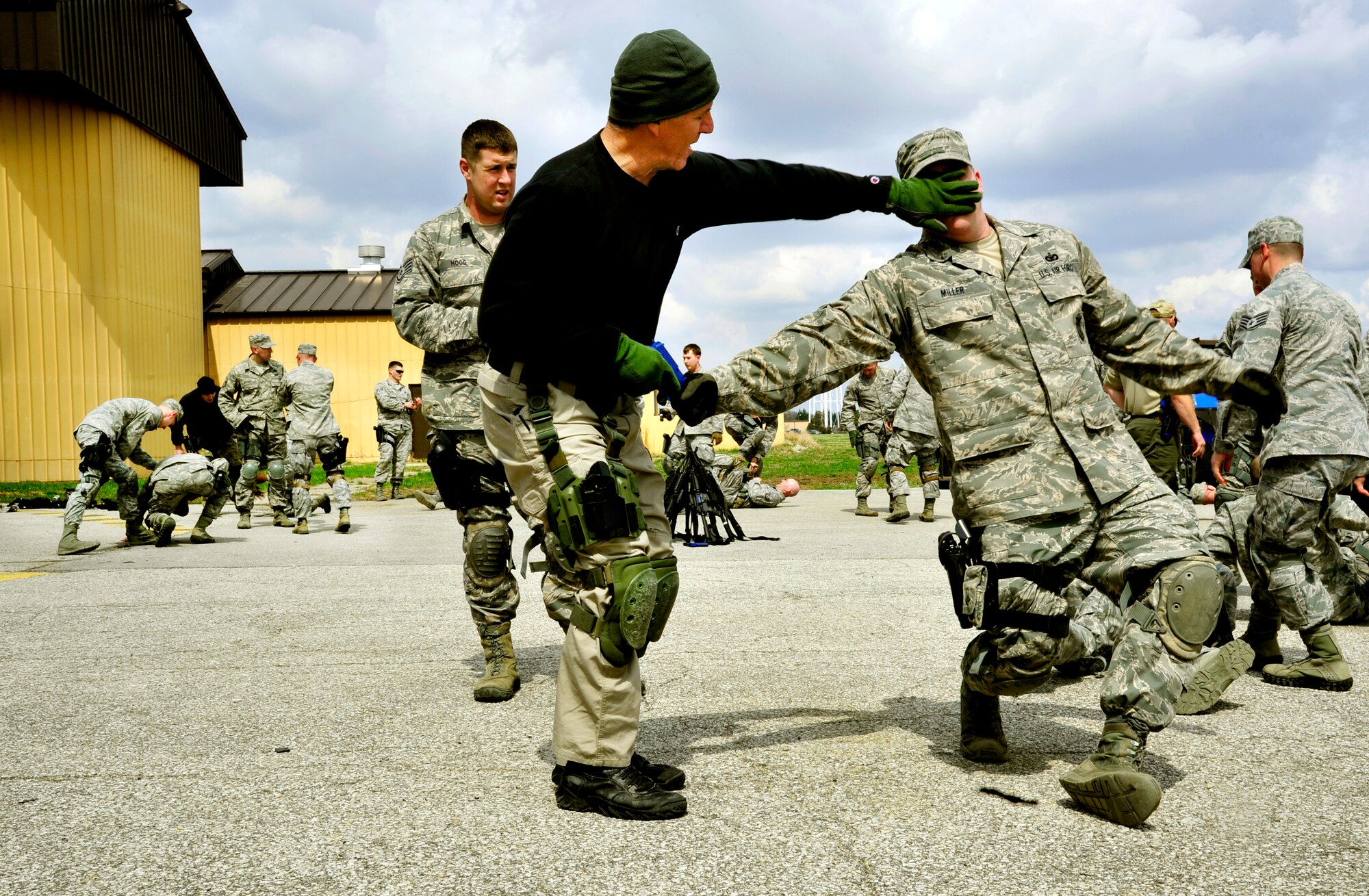 Ken Good, a former Navy SEAL, instructs Security Forces Squadron Airmen and law enforcement members how to defend themselves when someone is trying to take their weapon during Progressive Combat Solutions training at Scott Air Force Base, Ill., April 8, 2014. The Progressive Combat Solutions trains military and law enforcement personnel in decision making process originally benchmarked by the Air Force known as observe, orient, decide and act. The Air Mobility Command and the 375th Security Force Squadron hosted this training with the goal of implementing it across the AMC command in the future. (U.S. Air Force photo/Staff Sgt. Stephenie Wade)