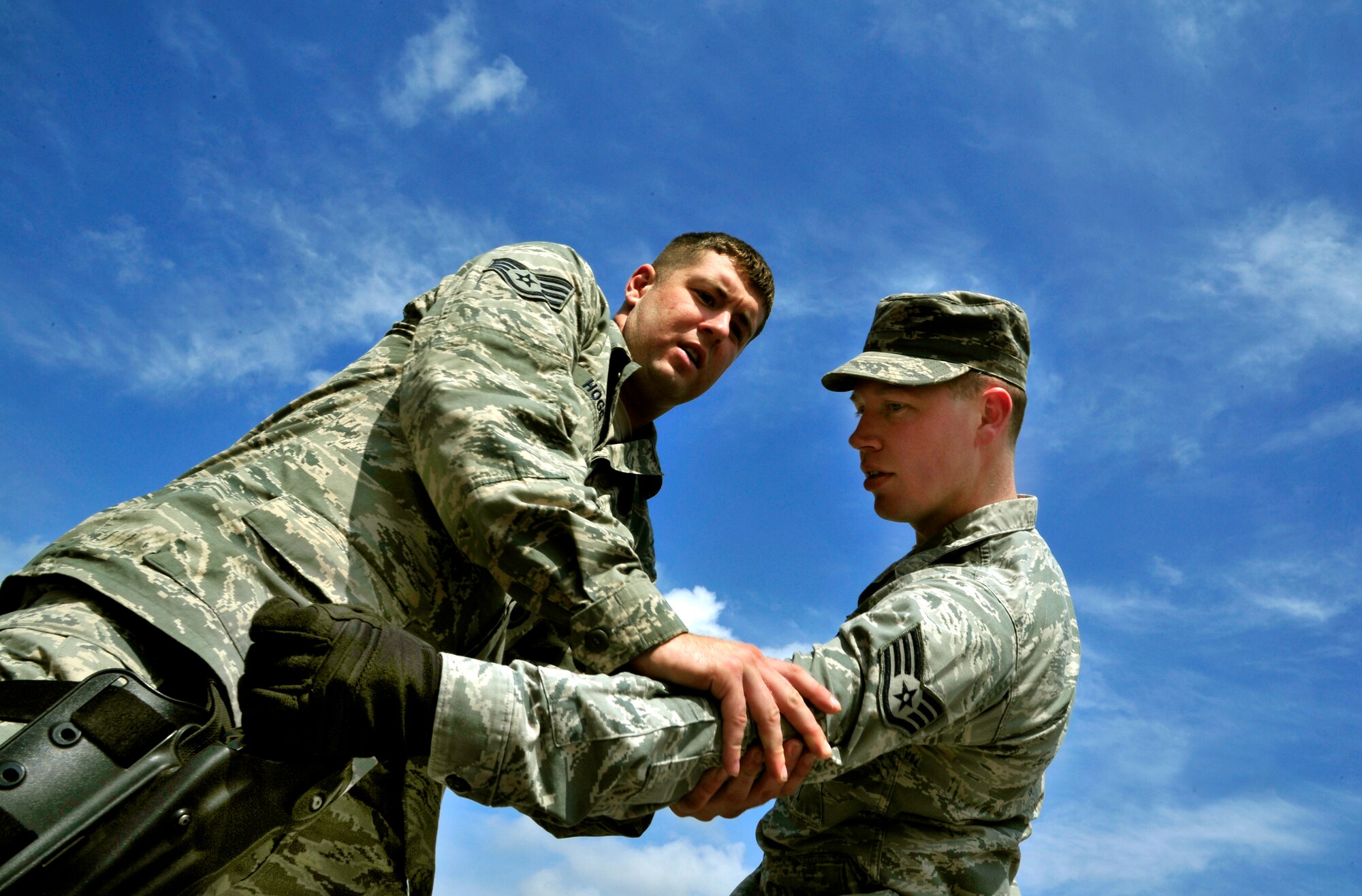 (Left to Right) Staff Sgt. Jonathan Hogg and Cody Shearer, Security Forces Squadron trainers practice defense tactics during Progressive Combat Solutions training at Scott Air Force Base, Ill., April 8, 2014. This training scenario will prepare members on how to defend themselves when a single person tries to take their weapon. The Progressive Combat Solutions trains military and law enforcement personnel in decision making process originally benchmarked by the Air Force known as observe, orient, decide and act. The Air Mobility Command and the 375th Security Force Squadron hosted this training with the goal of implementing it across the AMC command in the future. (U.S. Air Force photo/Staff Sgt. Stephenie Wade)