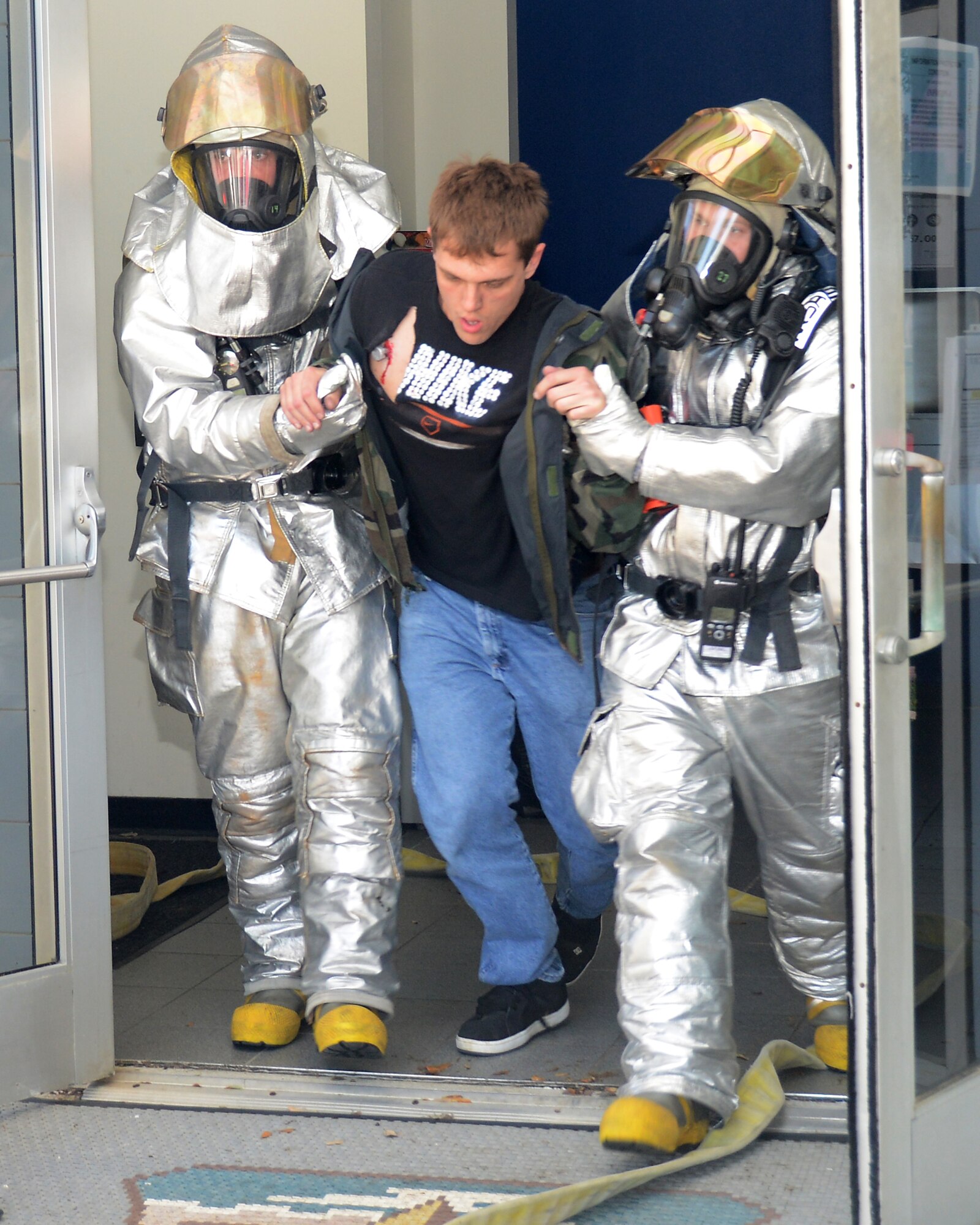 Members of the 147th Reconnaissance Wing Fire Department assist a simulated victim during a mass casualty exercise April 4,2014 at Ellington Field Joint Reserve Base, Houston, TX. The mass casualty scenario was part of an Operational Readiness Exercise that tested the Wing’s readiness and efficiency to respond to real world emergencies.
