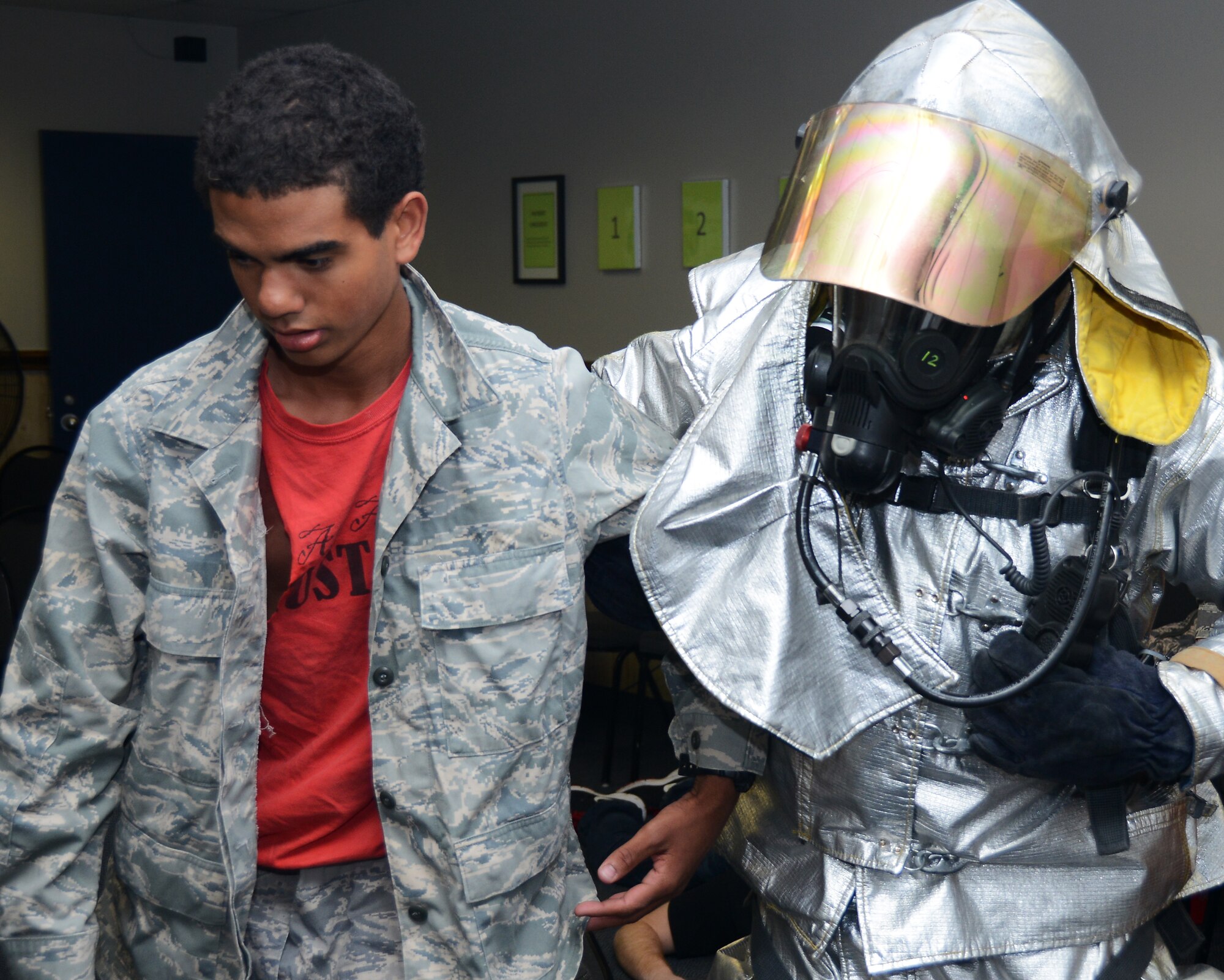 A member of the 147th Reconnaissance Wing Fire Department assist a simulated victim during a mass casualty exercise April 4,2014 at Ellington Field Joint Reserve Base, Houston, TX. The mass casualty scenario was part of an Operational Readiness Exercise that tested the Wing’s readiness and efficiency to respond to real world emergencies.
