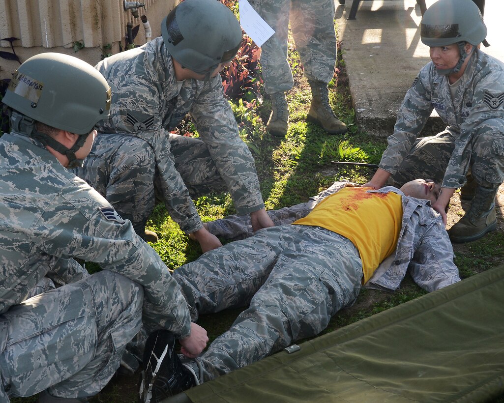 Members of the 147th Operations Group perform self-aid and buddy care (SABC) on a simulated victim during and Operational Readiness Exercise April 4, 2014 at Ellington Field Joint Reserve Base, Houston, TX. The Airmen were evaluated on there ability to respond after a simulated rocket attack on the base.