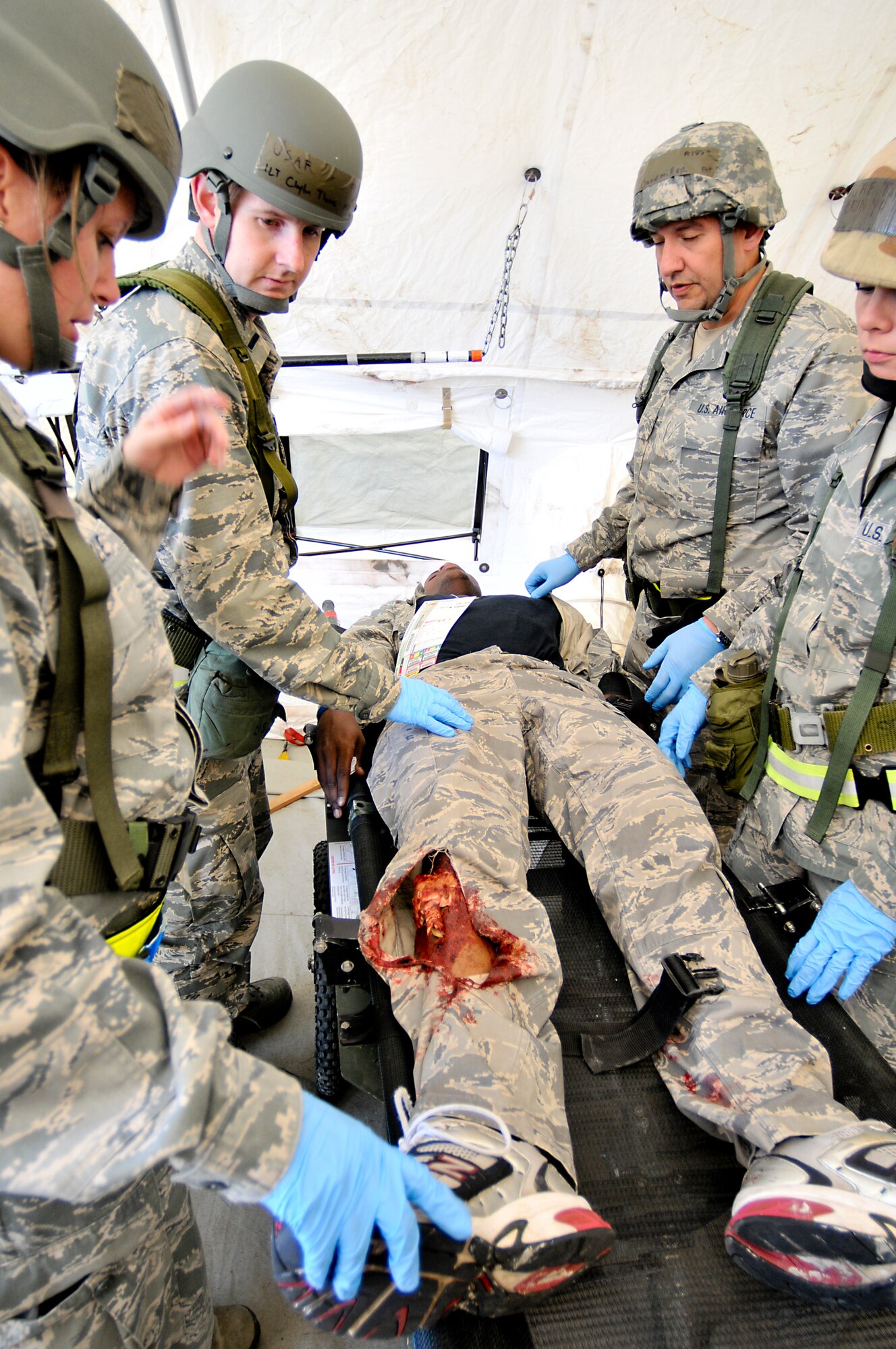 Members of the 147th Reconnaissance Wing Medical Group treat a simulated victim of a mass casualty event during an Operational Readiness Exercise April 4, 2014 at Ellington Field Joint Reserve Base, Houston, TX. The scenario tested the Medical Group's readiness and efficiency to respond to a real world event.