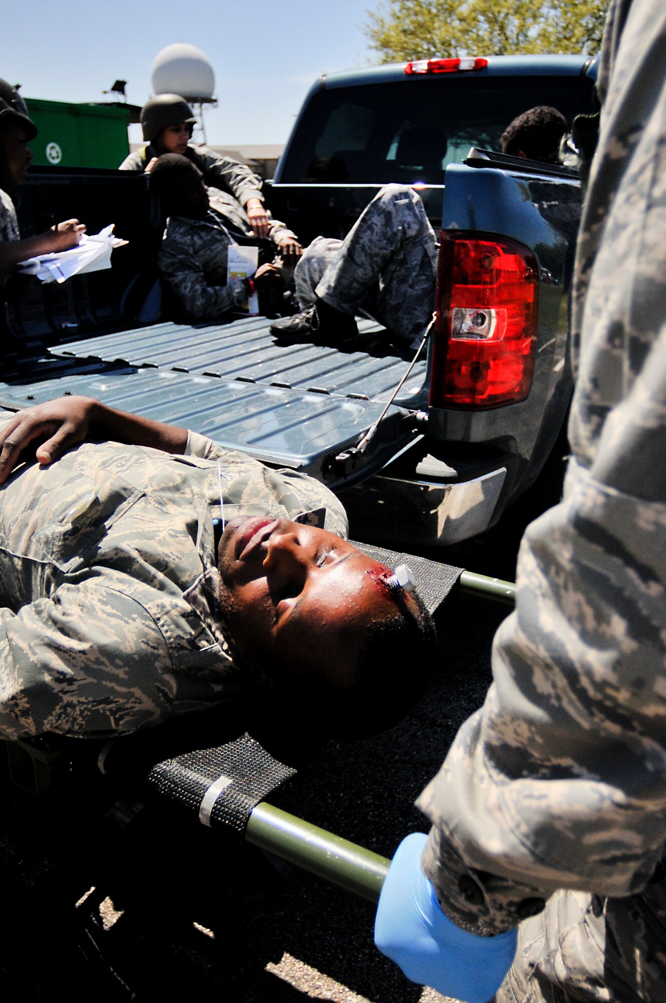 Members of the 147th Medical Group unload victims of a simulated mass casualty event April 4, 2014 at Ellington Field Joint Reserve Base, Houston, TX. The mass casualty scenario was part of an Operational Readiness Exercise that tested the 147th Reconnaissance Wing's readiness and efficiency to respond to real world events.