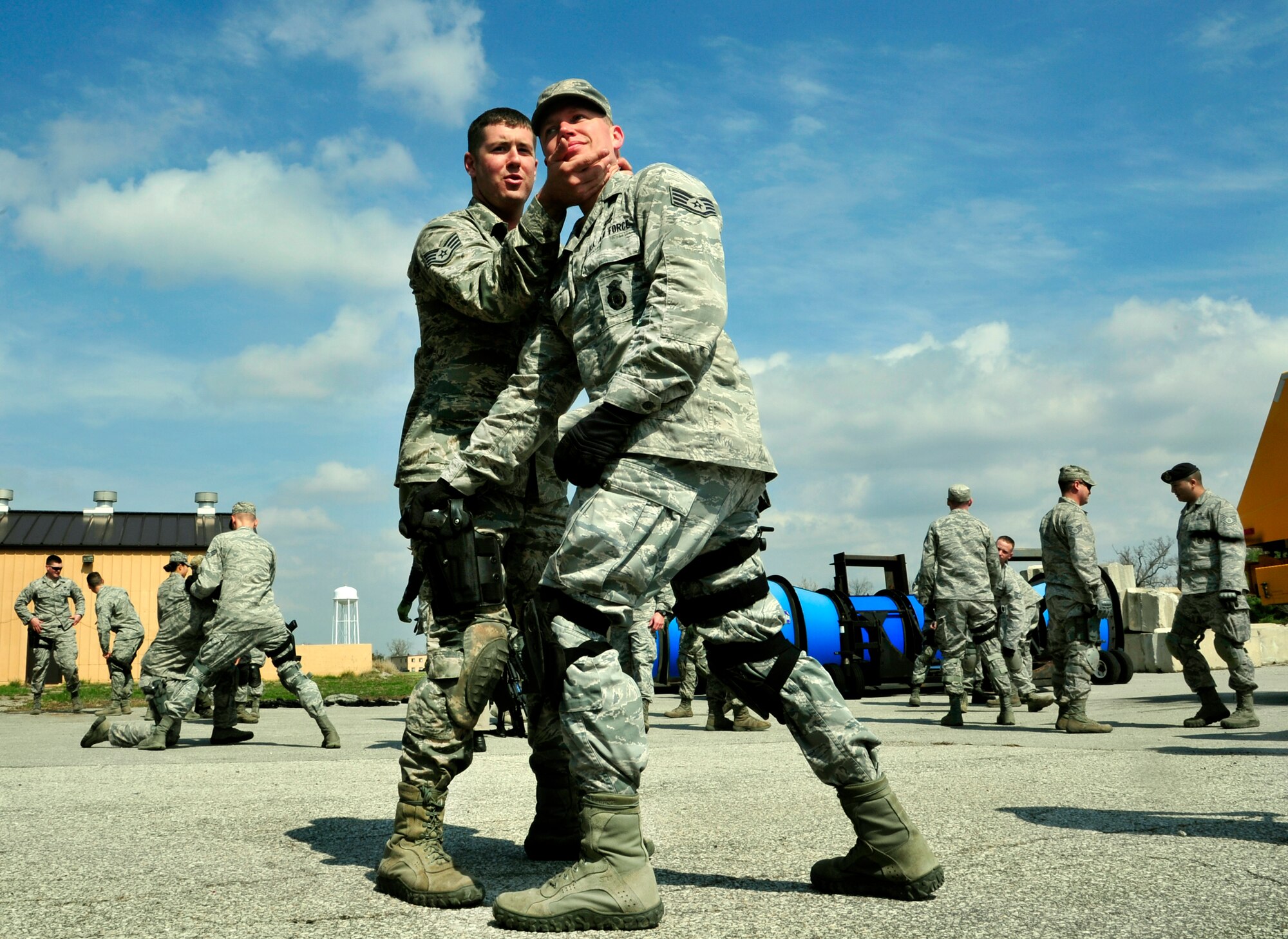 (Left to Right) Staff Sgt. Jonathan Hogg and Cody Shearer, Security Forces Squadron trainers practice defense tactics during Progressive Combat Solutions training at Scott Air Force Base, Ill., April 8, 2014. This training scenario will prepare members on how to defend themselves when a single person tries to take their weapon. The Progressive Combat Solutions trains military and law enforcement personnel in decision making process originally benchmarked by the Air Force known as observe, orient, decide and act. The Air Mobility Command and the 375th Security Force Squadron hosted this training with the goal of implementing it across the AMC command in the future. (U.S. Air Force photo/Staff Sgt. Stephenie Wade)