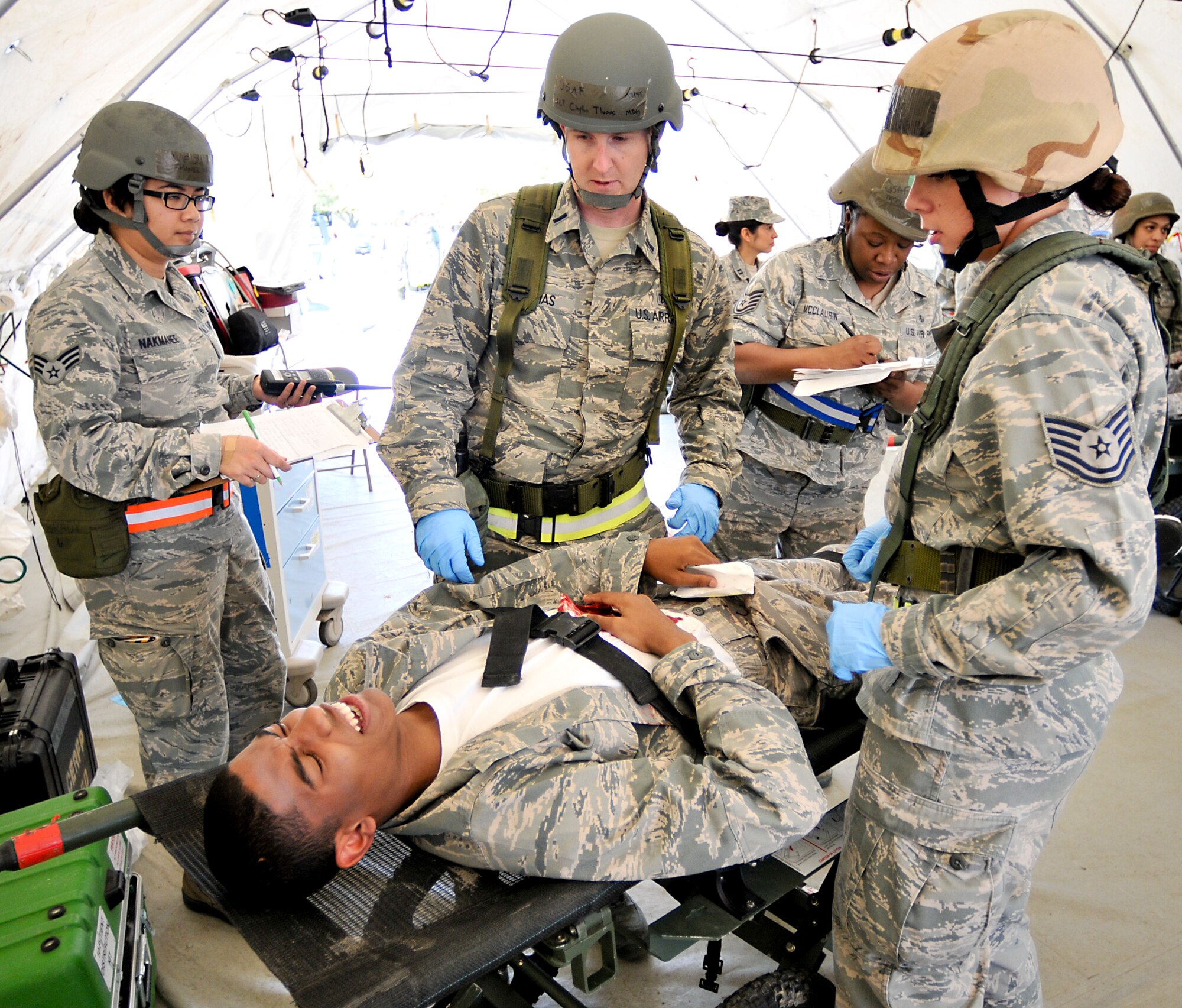 Members of the 147th Reconnaissance Wing Medical Group treat a simulated victim of a mass casualty event during an Operational Readiness Exercise April 4, 2014 at Ellington Field Joint Reserve Base, Houston, TX. The scenario tested the Medical Group's readiness and efficiency to respond to a real world event.
