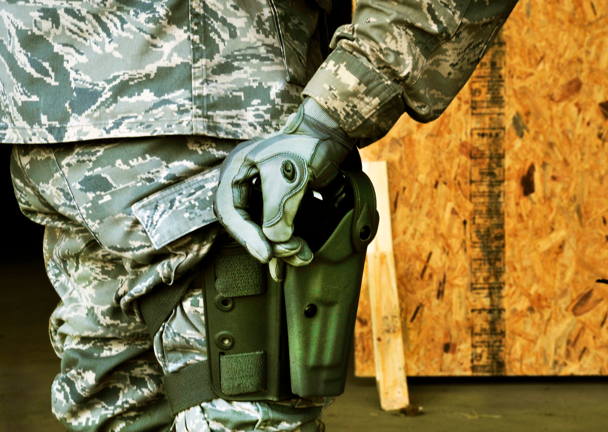 A Security Forces Squadron Airman attempts to grab anothers Airmans weapon during safe weapons handling procedures during Progressive Combat Solutions training at Scott Air Force Base, Ill., April 8, 2014. The Progressive Combat Solutions trains military and law enforcement personnel in decision making process originally benchmarked by the Air Force known as observe, orient, decide and act. The Air Mobility Command and the 375th Security Force Squadron hosted this training with the goal of implementing it across the AMC command in the future. (U.S. Air Force photo/Staff Sgt. Stephenie Wade)