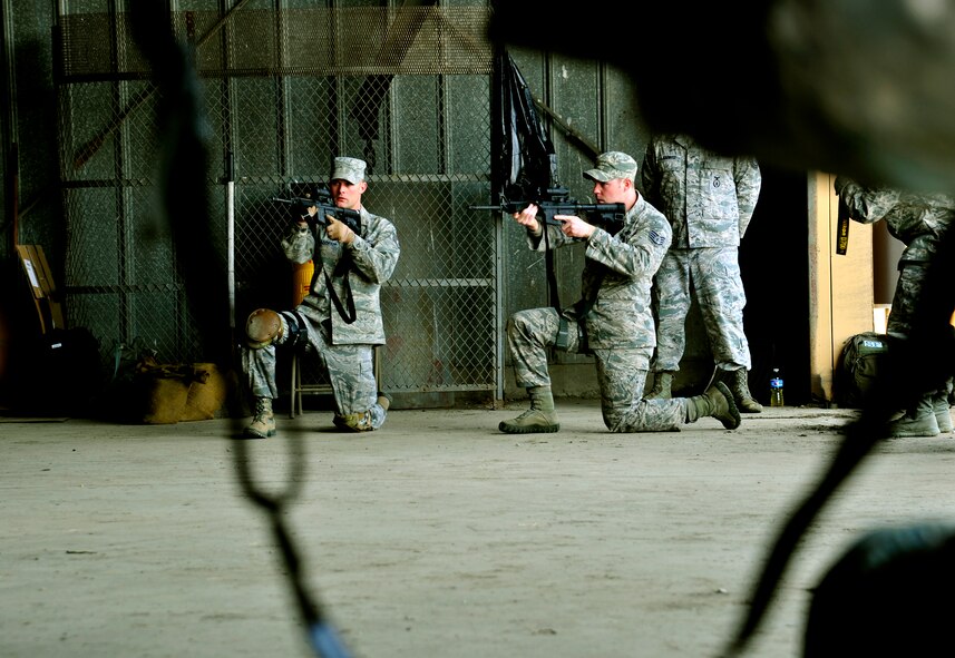 Ken Good, a former Navy SEAL, instructs Security Forces Squadron Airmen and law enforcement members on safe weapons handling procedures during Progressive Combat Solutions training at Scott Air Force Base, Ill., April 8, 2014. The Progressive Combat Solutions trains military and law enforcement personnel in decision making process originally benchmarked by the Air Force known as observe, orient, decide and act. The Air Mobility Command and the 375th Security Force Squadron hosted this training with the goal of implementing it across the AMC command in the future. (U.S. Air Force photo/Staff Sgt. Stephenie Wade)