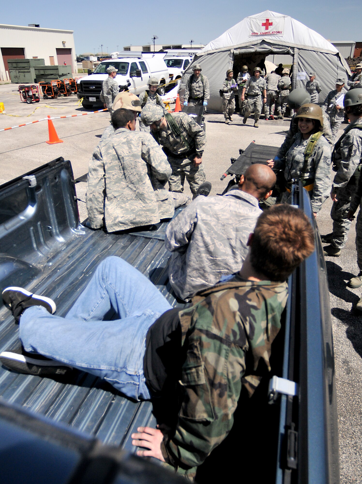 Members of the 147th Medical Group unload victims of a simulated mass casualty event April 4, 2014 at Ellington Field Joint Reserve Base, Houston, TX. The mass casualty scenario was part of an Operational Readiness Exercise that test the 147th Reconnaissance Wing's readiness and efficiency to respond to real world events.