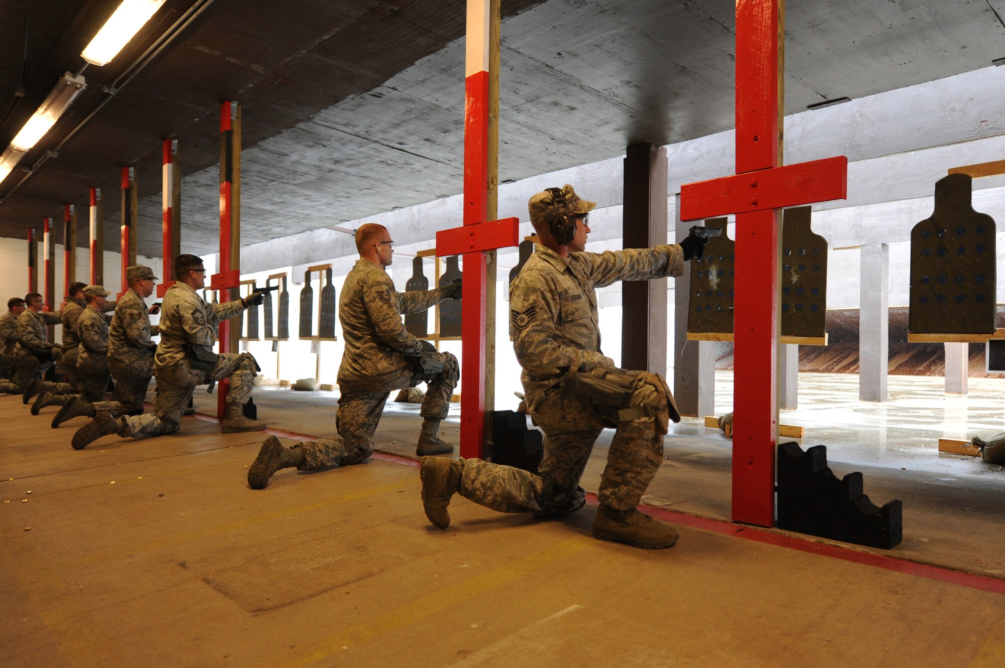 Security forces members from across the Air Mobility Command, members of the FBI, and St. Clair County police officers shoot with their non-dominant hand during training at Scott Air Force Base, Ill. on April 7, 2014. Sixteen bases and agencies came together for a week-long training aimed at highing training standards. (U.S. Air Force photo/Senior Airman Sarah Hall-Kirchner)