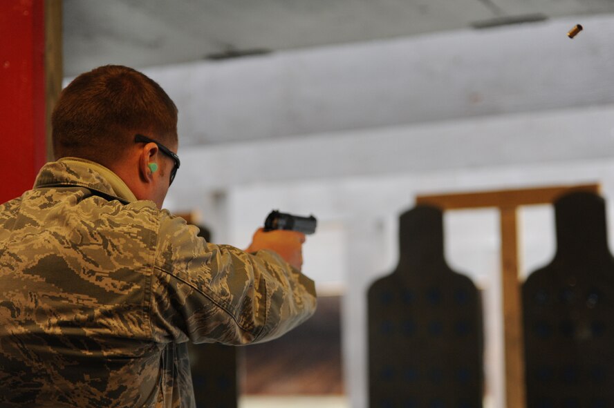 Maj. James Allen, Air Combat Command defender from Joint Base Langley-Eustis, shoots his weapon during security forces training at Scott Air Force Base, Ill. on April 7, 2014. Sixteen bases and agencies came together for a week-long training aimed at highering standards for security forces training. (U.S. Air Force photo/Senior Airman Sarah Hall-Kirchner)