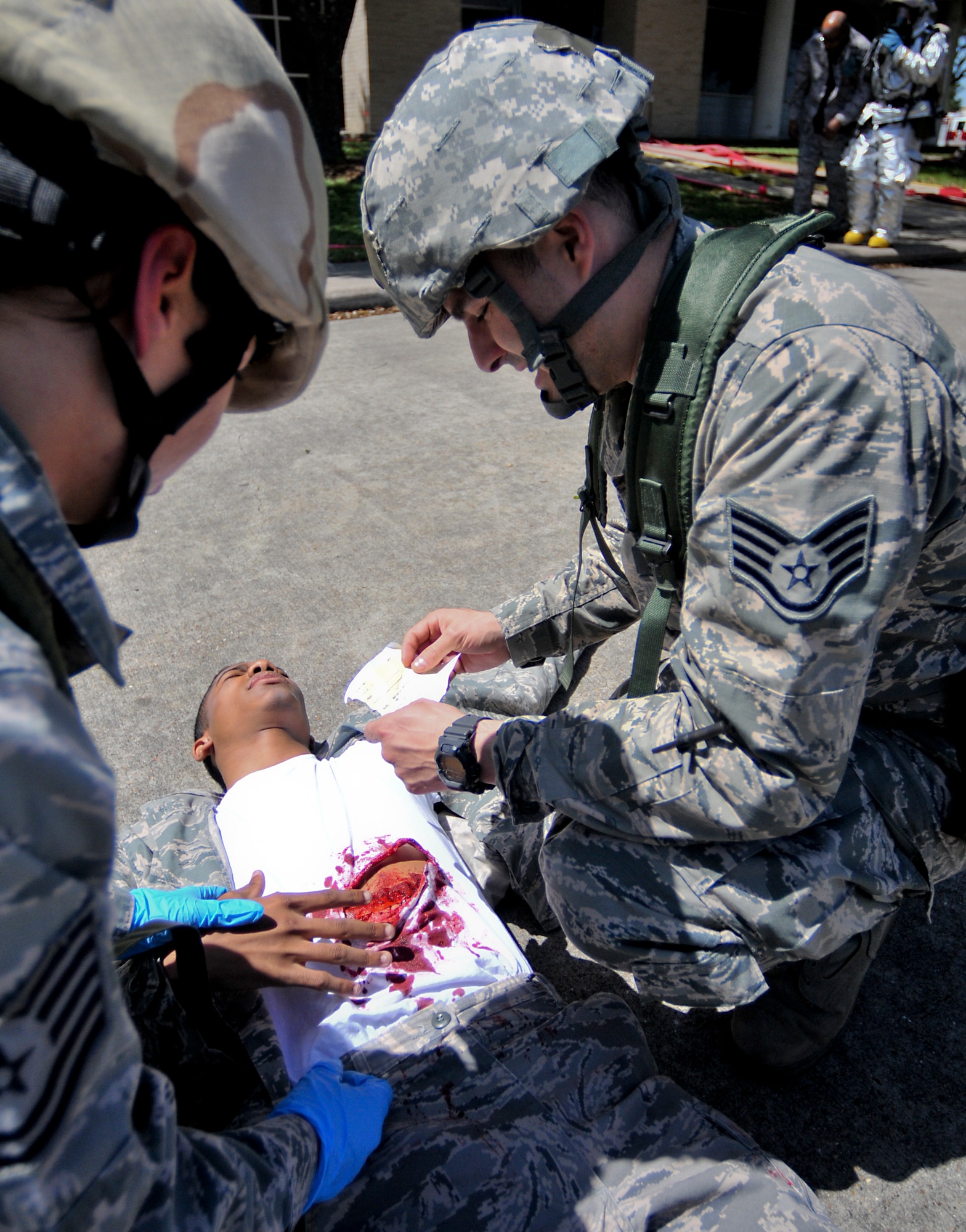 Members of the 147th Medical Group treat a simulated victim during a mass casualty scenario as part an Operational Readiness Exercise at Ellington Field Joint Reserve Base, Houston, April 4, 2014. The mass casualty scenario tested the capabilities of both the fire department and the medical groups ability to respond to a real world emergency.