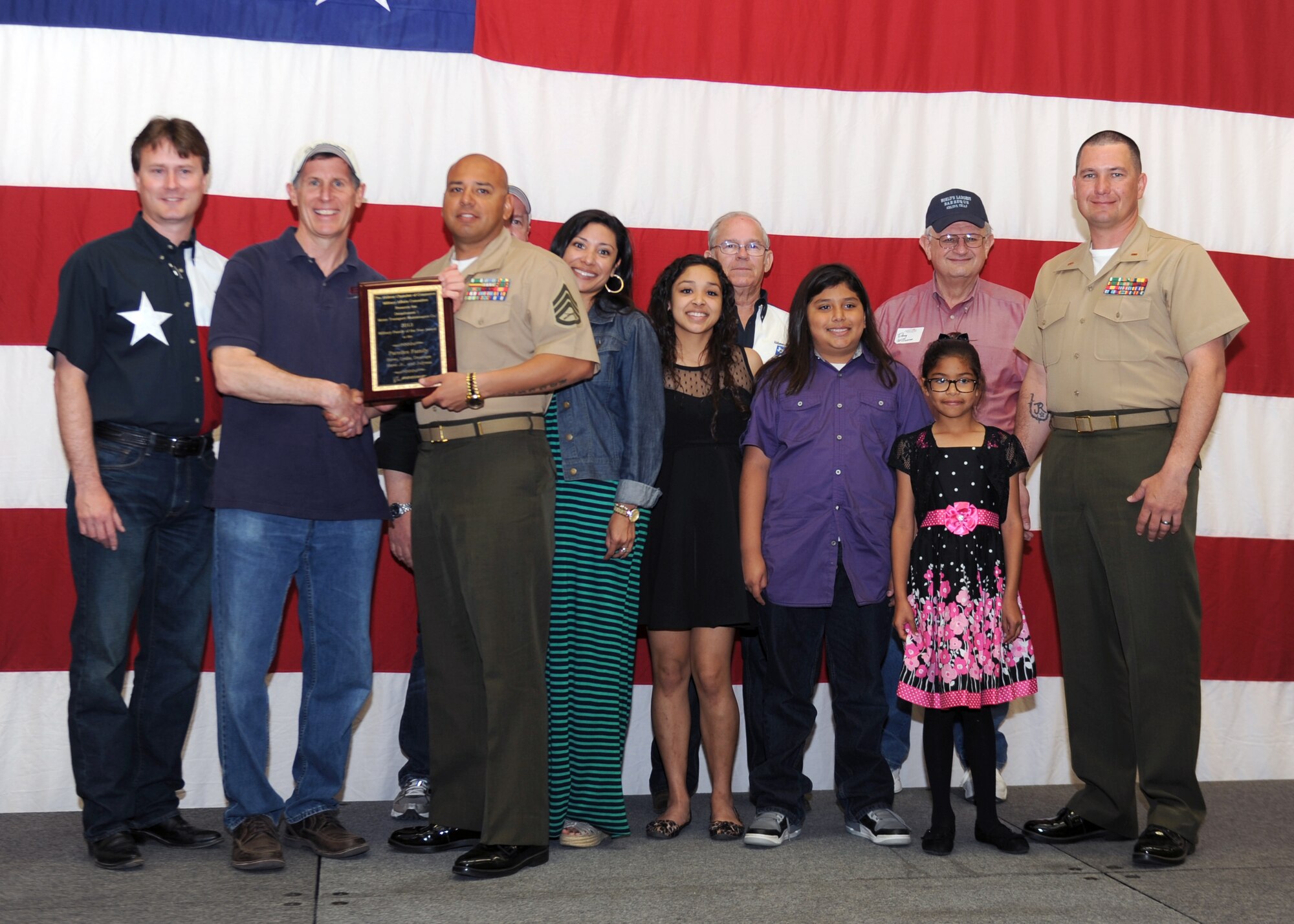 The Abilene Military Affairs Committee presents the 2014 Military Family of the Year Award to the Paredes Family April 12, 2014, at the Civic Center in Abilene, Texas. The purpose of the award is to recognize a military family who has contributed to the military and local community through volunteer service and community involvement. The MAC presents the award annually at the World’s Largest Barbecue. (U.S. Air Force photo by Airman 1st Class Kedesha Pennant/Released)

