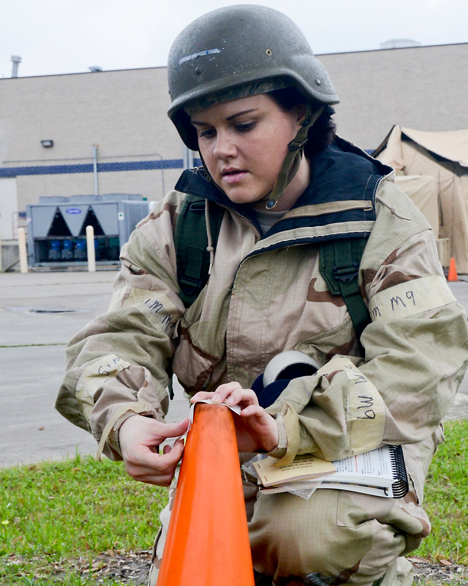 Staff Sgt. Holli Yeagley, 147th Force Support Squadron, places simulated chemical agent detection paper around a building during and Operational Readiness Exercise, April 3, 2014 at Ellington Field Joint Reserve Base. The exercise tested the wing's readiness to respond to various wartime scenarios.