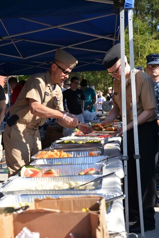 Commander Theron Davis, Naval Nuclear Power Training Command executive officer, serves NNPTC students during the NNPTC bi-monthly barracks bash cookout April 11, 2014, on Joint Base Charleston – Weapons Station, S.C. During the event, students enjoyed a cookout, played games and participated in fundraising events for Sexual Assault Awareness Month. (US Navy photo/Petty Officer 3rd Class Jason Pastrick)