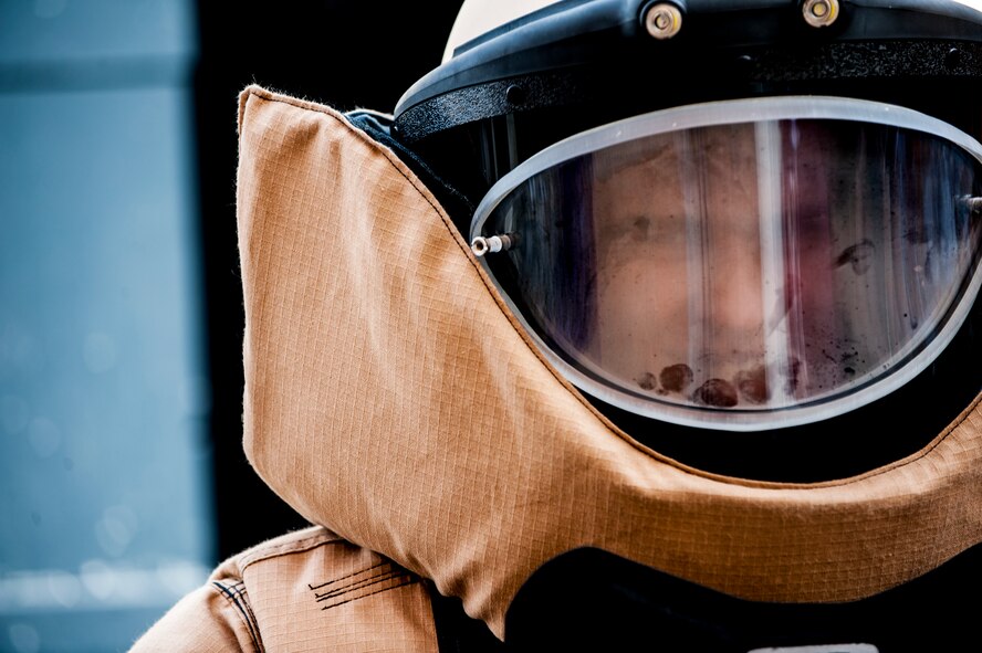 A student from Minot High School Magic City Campus tries on an Explisve Ordinance Disposal suit in Minot, N.D., April 11, 2014. Minot Air Force Base's EOD team visited the school to give demonstrations and talk about their mission. (U.S. Air Force photo/Airman 1st Class Apryl Hall)