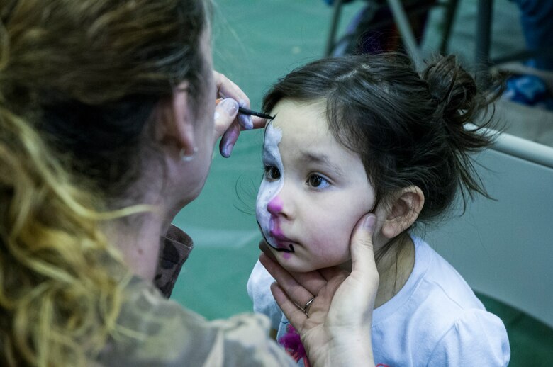 Jessica Wheeler applies paint on Sorea Perez’s face during Spring Fling on April 12, 2014, at Schriever Air Force Base, Colo. Spring Fling is an opportunity for the Schriever community to get together for a fun-filled event. Sorea is the daughter of Capt. Juan Perez, 3rd Space Experimentation Squadron. (U.S. Air Force photo/Staff Sgt. Julius Delos Reyes)