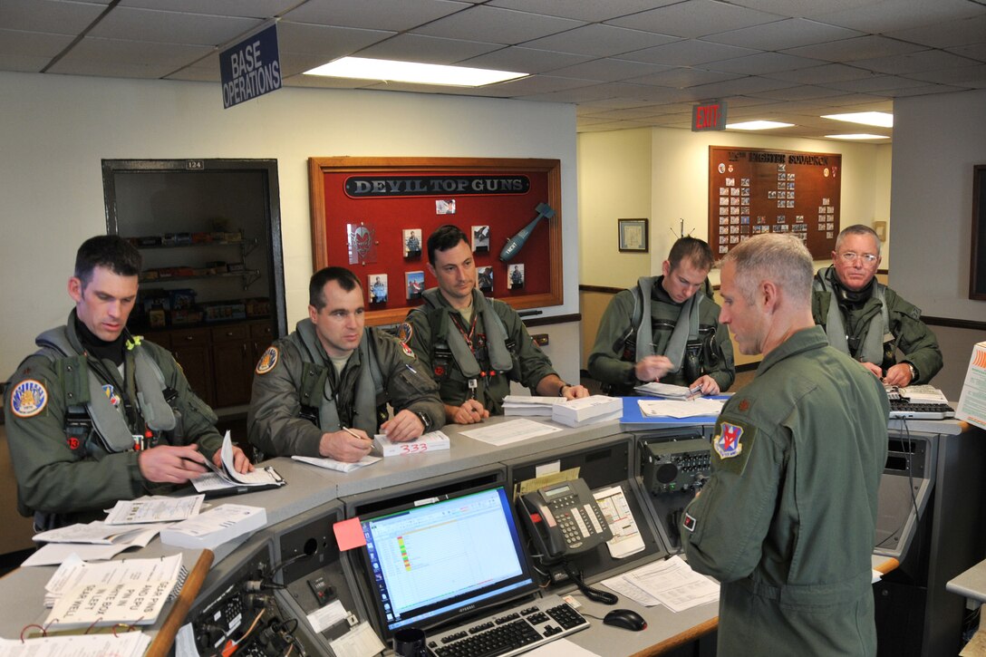 From right, Lt. Gen. William H. Etter, Commander of Continental U.S. North American Aerospace Defense Command Region - 1st Air Force, goes through a pre-flight brief with F-16 fighter pilots from the New Jersey Air National Guard's 177th Fighter Wing at the Atlantic City Air Guard Base on April 3, 2014. (U.S. Air National Guard photo by Master Sgt. Andrew J. Moseley/Released)