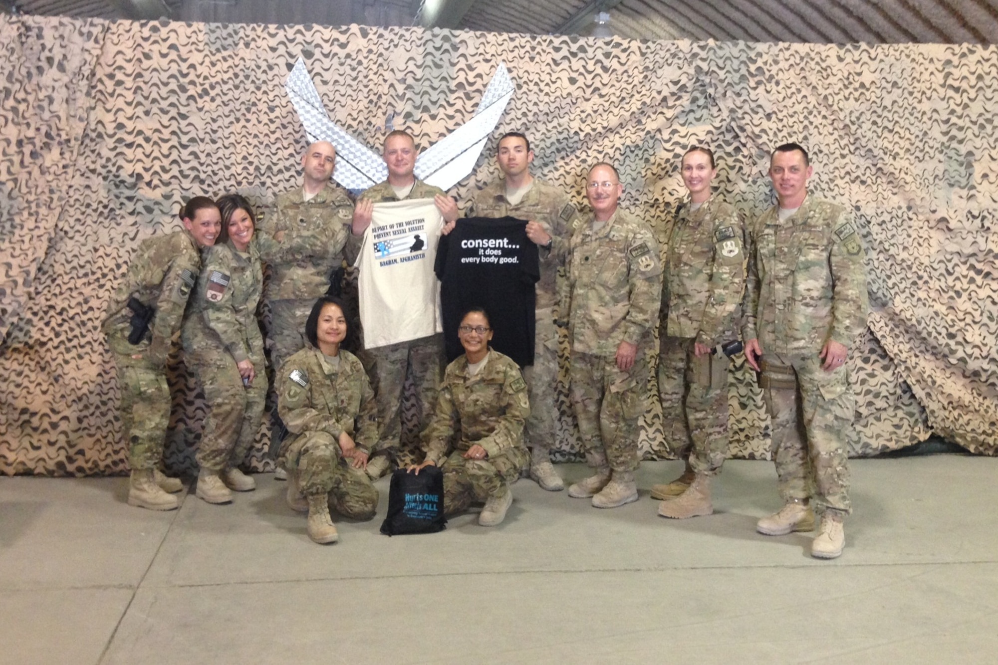 Maj. December Garcia (bottom left), Air Force Sexual Assault Response Coordinator for Afghanistan, poses April 11, 2014, with members of the 451st Air Expeditionary Group team of Judge Advocates, First Sergeants, Victim Advocates and Chaplain who provide valuable assistance to the SARC program at Kandahar Airfield, Afghanistan. Garcia conducts routine visits with multiple units throughout Afghanistan to provide prevention and response information to Airmen. (Courtesy Photo)