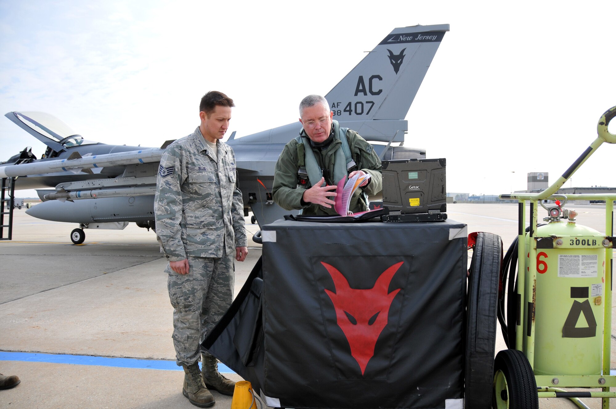 From right, Lt. Gen. William H. Etter, Commander of Continental U.S. North American Aerospace Defense Command Region - 1st Air Force, and Staff Sgt. Ben Ellis, crew chief from the New Jersey Air National Guard's 177th Fighter Wing at the Atlantic City Air Guard Base, perform pre-flight checks on April 3, 2014. (U.S. Air National Guard photo by Master Sgt. Andrew J. Moseley/Released)