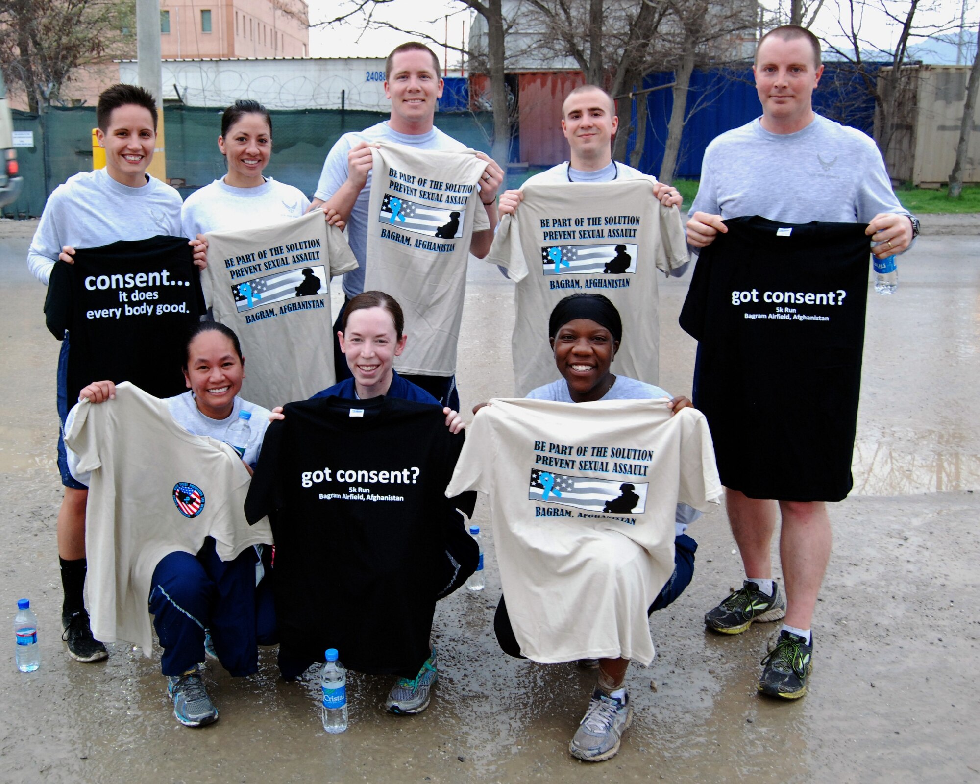 Airmen pose with T-shirts they received after completing the Sexual Assault Awareness Month 5K run at Bagram Airfield, Afghanistan, April 4, 2014. There were over 600 participants at the event. (U.S. Air Force photo by Capt. Brian Wagner/Released)