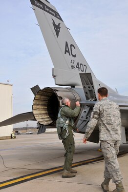 From left, Lt. Gen. William H. Etter, Commander of Continental U.S. North American Aerospace Defense Command Region - 1st Air Force, and Staff Sgt. Ben Ellis, crew chief from the New Jersey Air National Guard's 177th Fighter Wing at the Atlantic City Air Guard Base, perform pre-flight checks on April 3, 2014. (U.S. Air National Guard photo by Master Sgt. Andrew J. Moseley/Released)