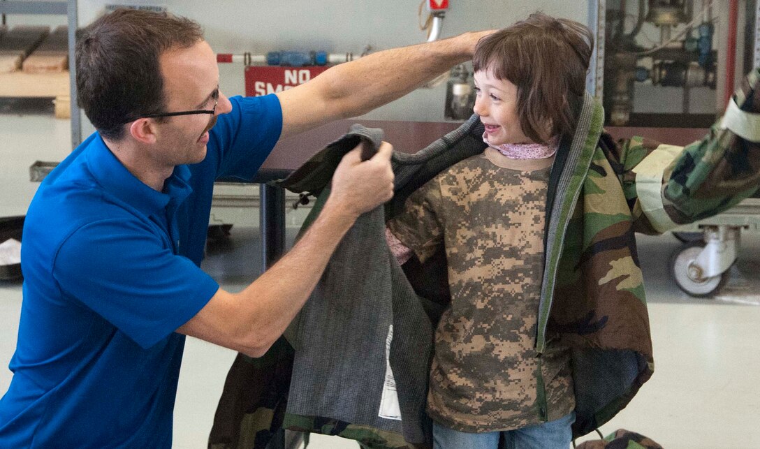 Military dependent children get hands on with MOPP gear during Operations KIDS (Kids Investigating Deployment Services) April 5, at Sheppard Air Force Base. Operation KIDS gave children an opportunity to achieve a better perspective and understanding on what their parents go through during a deployment. (U.S. Air Force photo/Airman 1st Class Robert L. McIlrath)