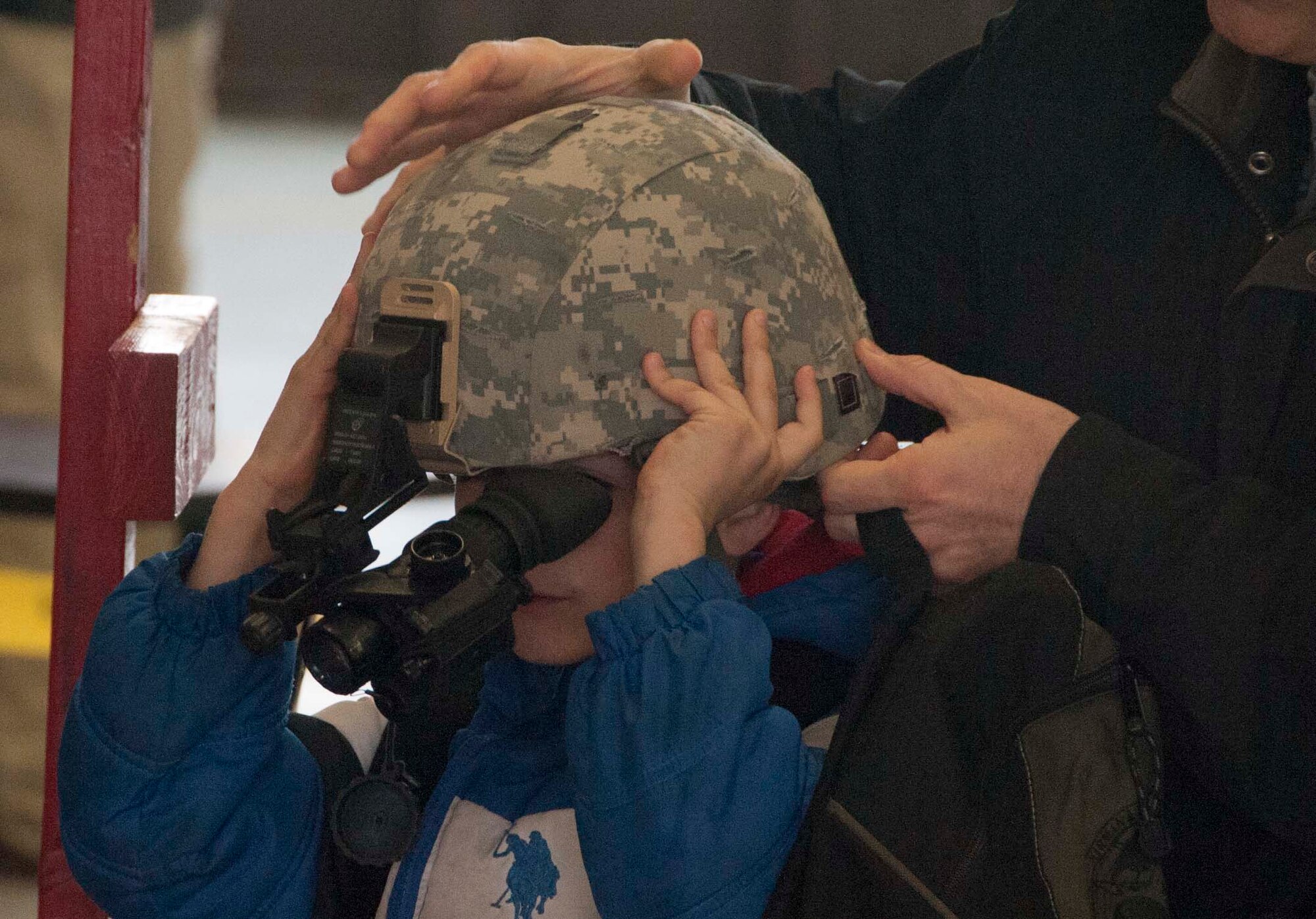 Military dependent children get hands on with Kevlar helmets equipped with night vision goggles during Operations KIDS (Kids Investigating Deployment Services) April 5, at Sheppard Air Force Base. Operation KIDS gave children an opportunity to achieve a better perspective and understanding on what their parents go through during a deployment. (U.S. Air Force photo/Airman 1st Class Robert L. McIlrath)