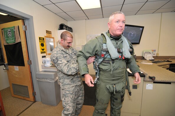 From right, Lt. Gen. William H. Etter, Commander of Continental U.S. North American Aerospace Defense Command Region - 1st Air Force, is fitted with an exposure suit, G-suit and ejection seat harness by Technical Sgt. Joe Searle, Aircrew Flight Equipment NCO, with the New Jersey Air National Guard's 177th Fighter Wing at the Atlantic City Air Guard Base on April 2, 2014. (U.S. Air National Guard photo by Master Sgt. Andrew J. Moseley/Released)