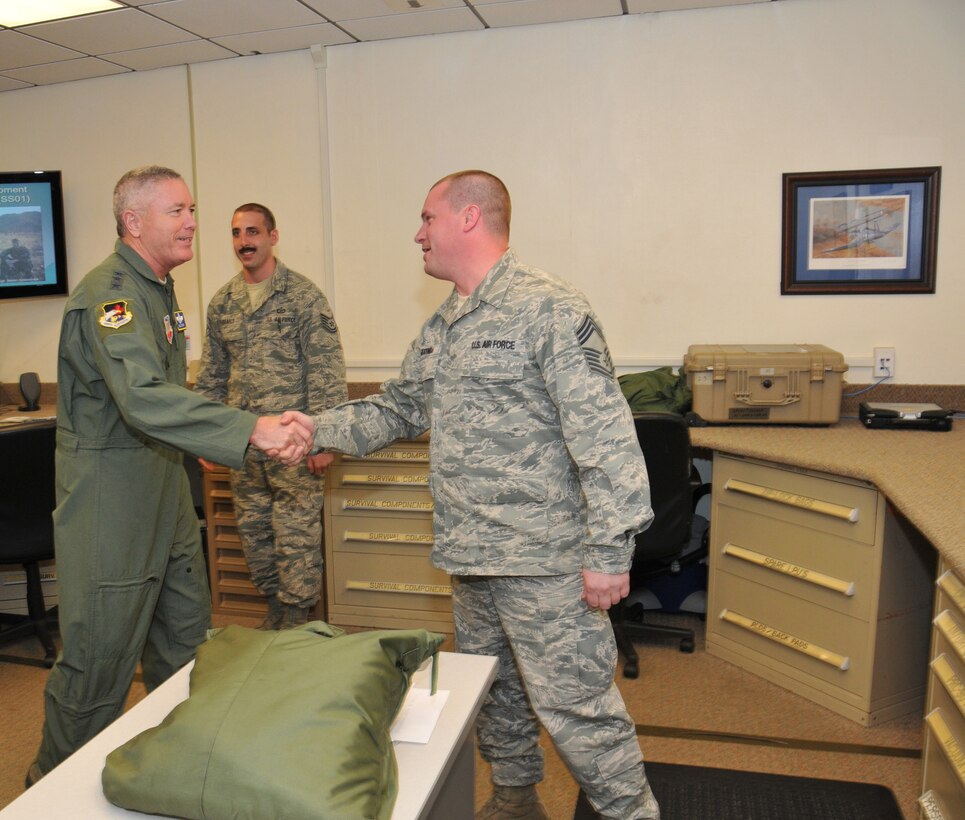 Lt. Gen. William H. Etter, Commander of Continental U.S. North American Aerospace Defense Command Region - 1st Air Force, shakes hands with Chief Master Sgt. Jason Gioconda, Aircrew Flight Equipment NCOIC, with the New Jersey Air National Guard's 177th Fighter Wing at the Atlantic City Air Guard Base on April 2, 2014. (U.S. Air National Guard photo by Master Sgt. Andrew J. Moseley/Released)