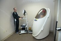 Karl Leonard, exercise physiologist, Health & Wellness Center measures the lean body mass percentage of Master Sgt. Bartholomew Vasquez on the Bod Pod April 15, 2014 at Joint Base San Antonio-Randolph. (U.S. Air Force photo by Joel Martinez)