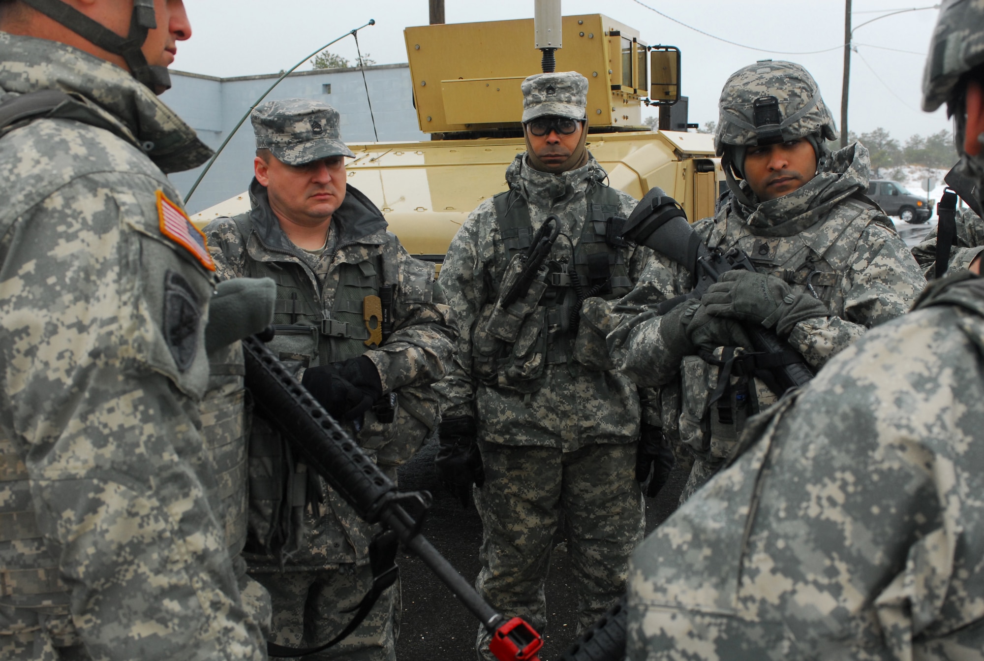 Observer-coach/trainer Sgt 1st Class Aaron Hammond (left), 2-289th Field Artillery Battalion, 157th Infantry Brigade, and Sgt 1st Class Carlos Rivera (right), 1-314th Infantry Regiment, 174th Infantry Brigade provides guidance to the Soldiers of the 401st Chemical Company during an informal after actions review discusses with peer observer-coach/trainers from 1-314th Infantry Regiment, 174th Infantry Brigade the training objectives for the 401st Chemical Company Exercise at Joint Base McGuire Lakehurst Dix, N.J. (U.S. Army photo by 1st Lt. Gerrelaine Alcordo/Released)
