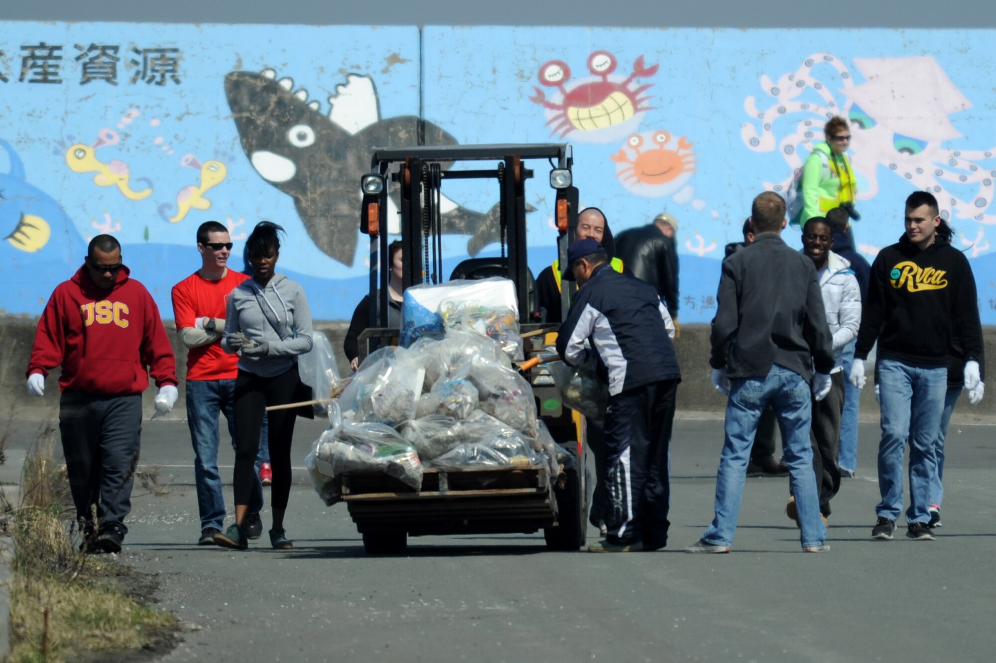 Members from Misawa Air Base and Misawa City pick up trash during the 17th Annual Misawa Fish Port Cleanup in Misawa City, Japan, April 12, 2014. Promoting Earth Day and Japan’s Greenery Day, more than 500 volunteers from both Misawa Air Base and Misawa City assisted the 35th Civil Engineer Squadron environmental office with the collection of about 9,000 pounds of trash. (U.S. Air Force Tech. Sgt. April Quintanilla)
