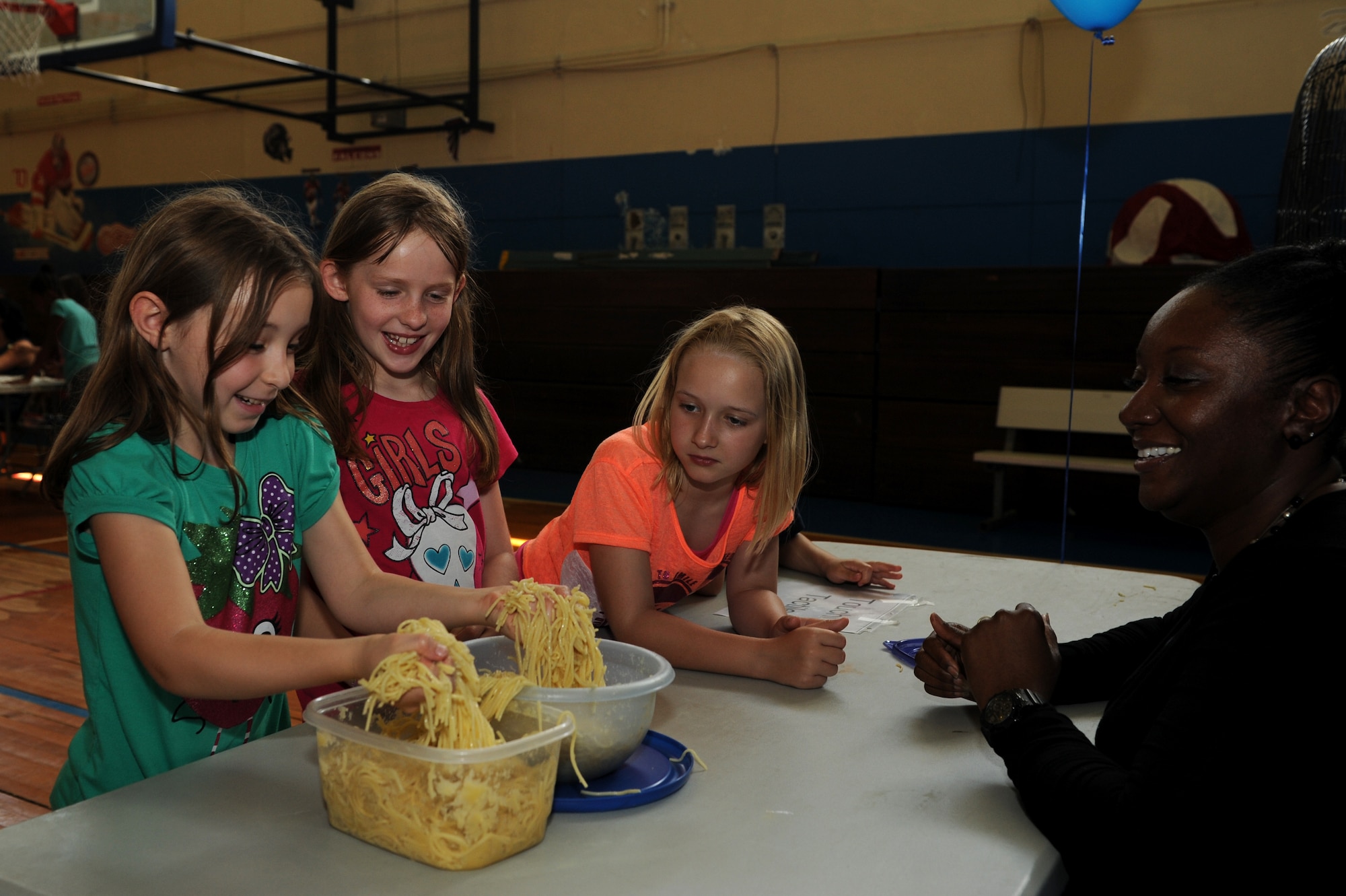 Children with the Himiwari School Age Program participate in a touch test booth during the Autism Awareness Fair at the youth center on Kadena Air Base, Japan, April 10, 2014. One bowl was filled with regular spaghetti and the other was filled with spaghetti and apple sauce. To someone with autism, spaghetti may feel like the mixture of spaghetti and apple sauce, whereas someone who does not have autism would feel something different. Each booth at the fair represented a different sense, such as seeing, smelling, hearing, touching and tasting, and how these senses would affect someone with Autism. (U.S. Air Force photo by Airman 1st Class Hailey R. Staker)
