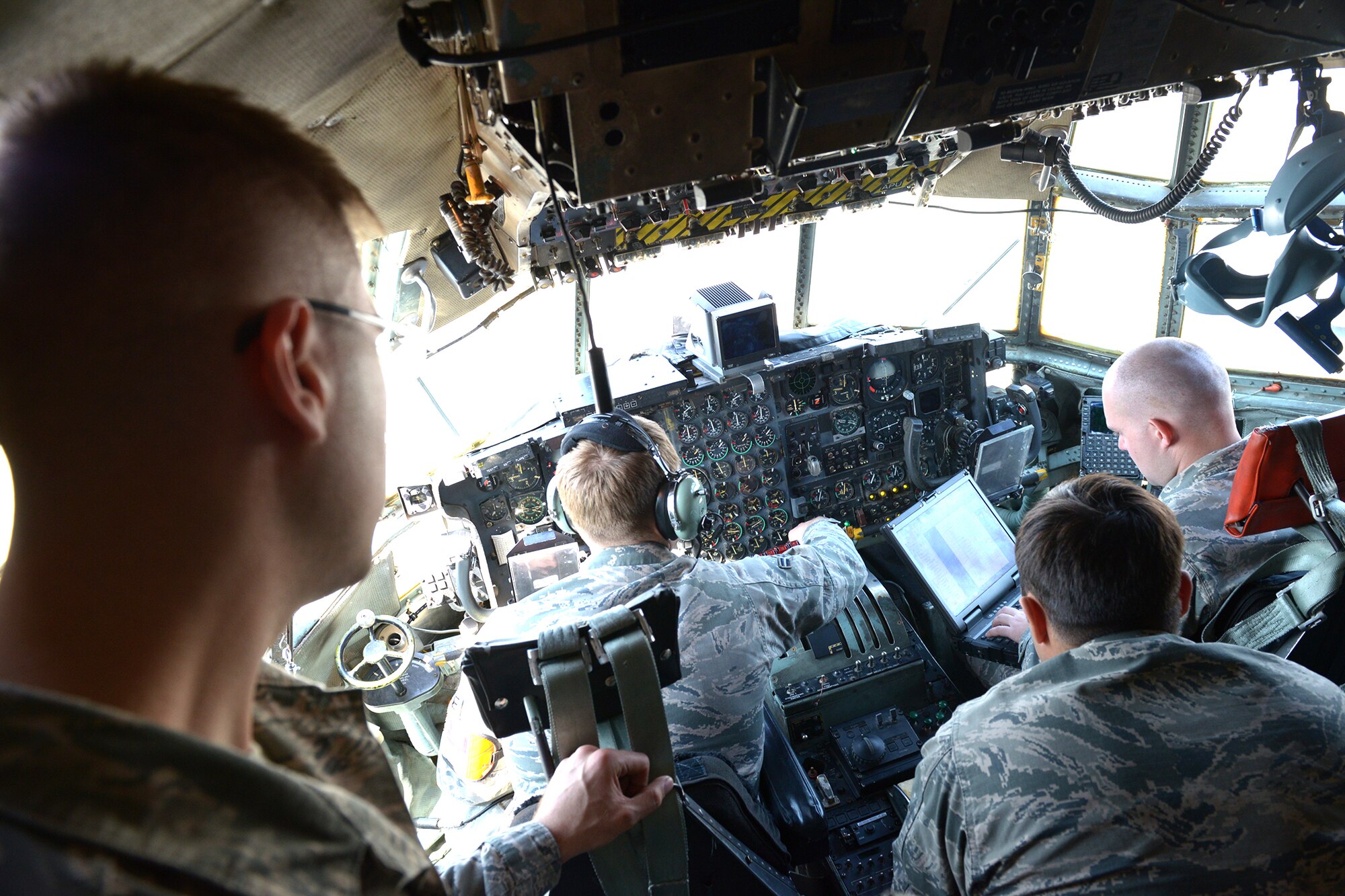 Staff Sgt. Jonathan Callahan, 374th Maintenance Group crew chief quality assurance inspector, observes airmen from the 374th Aircraft Maintenance Squadron as they perform a propeller oil service check at Yokota Air Base, Japan, April 8, 2014. Maintenance is performed to ensure that aircraft remain in peak condition to support any operation. (U.S. Air Force photo by Airman 1st Class David Danford/Released)