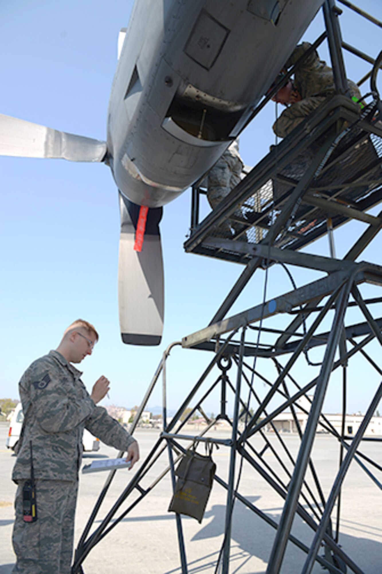 Staff Sgt. Jonathan Callahan, 374th Maintenance Group crew chief quality assurance inspector, performs a spot inspection on members of the 374th Aircraft Maintenance Squadron at Yokota Air Base, Japan, April 8, 2014. Spot checks are conducted randomly to promote safety and standards compliance. (U.S. Air Force photo by Airman 1st Class David Danford/Released)