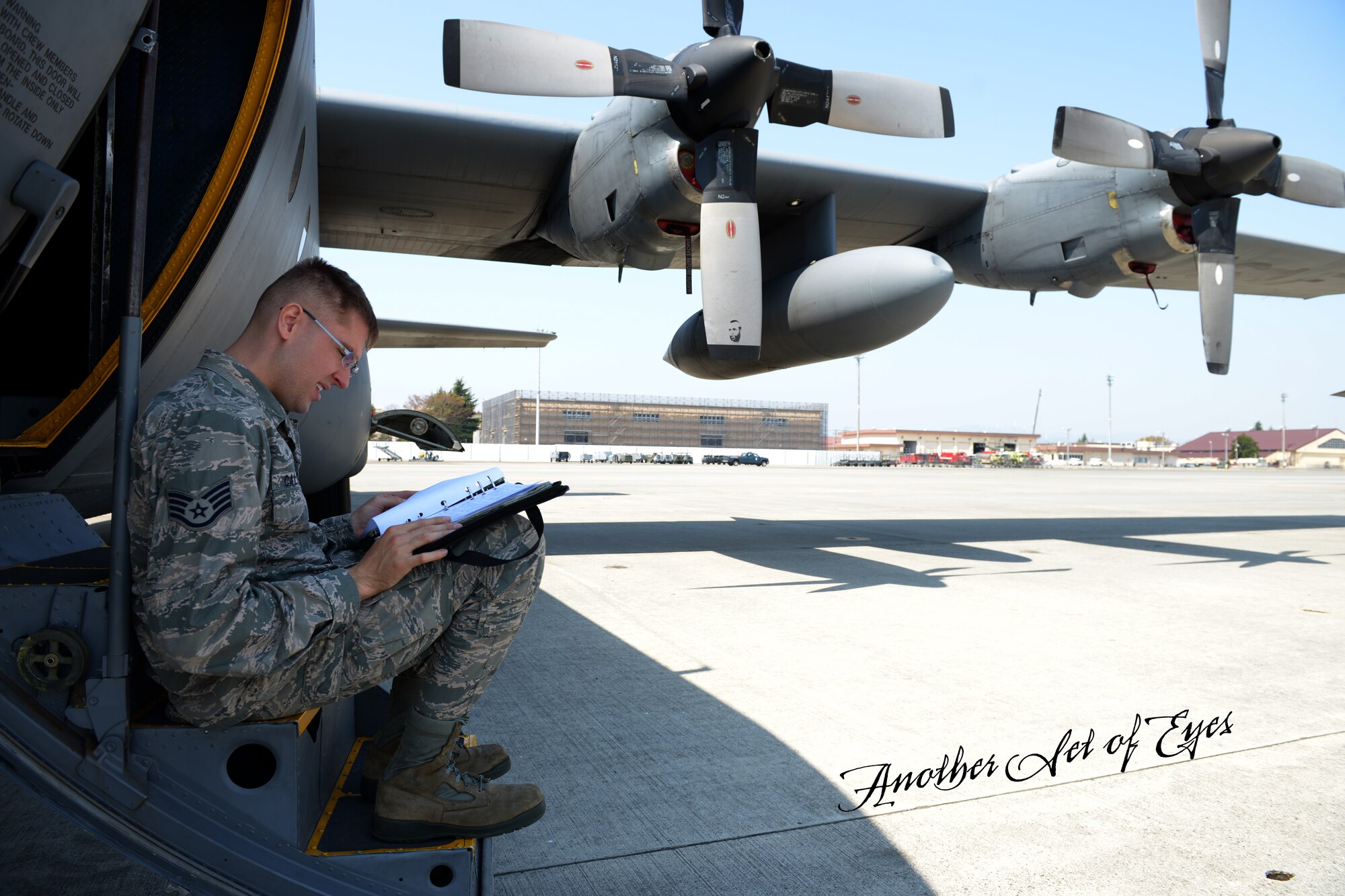 Staff Sgt. Jonathan Callahan, 374th Maintenance Group crew chief quality assurance inspector, reviews inspection logs at Yokota Air Base, Japan, April 8, 2014. Callahan takes note of and reports any discrepancies to ensure compliance with Air Force standards. (U.S. Air Force photo illustration by Airman 1st Class David Danford/Released)
