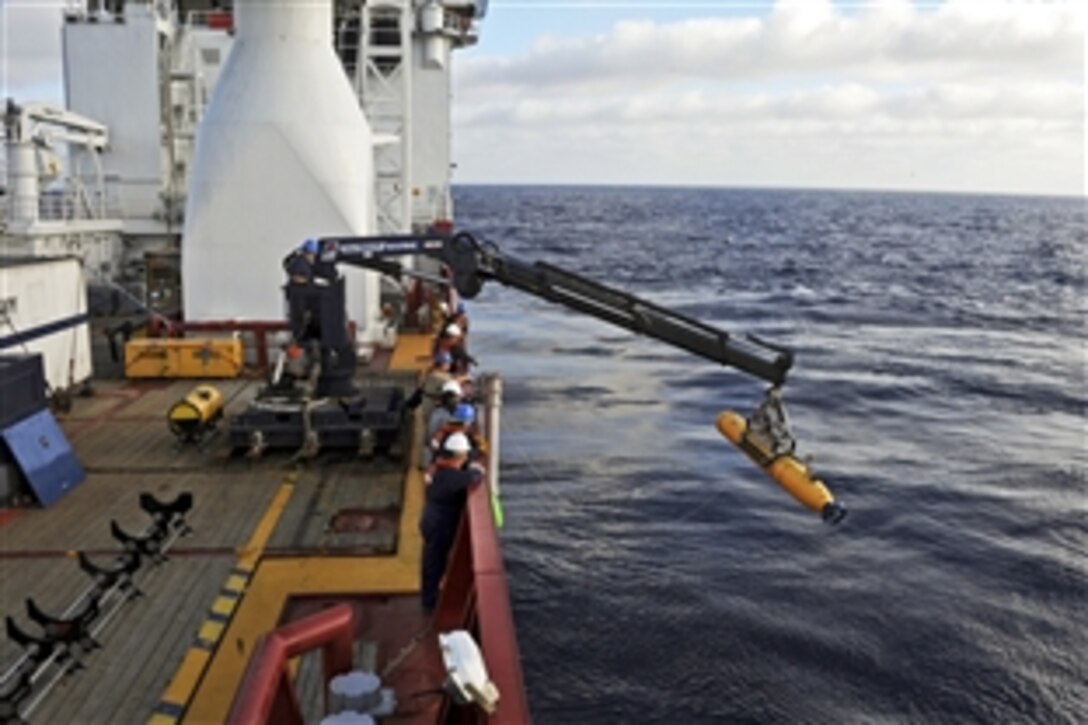 Operators aboard the Ocean Shield, an Australian navy ship, move the U.S. Navy's Bluefin 21 Artemis autonomous underwater vehicle into position to deploy it in the Indian Ocean, April 14, 2014. Using side-scan sonar, the Bluefin will descend to a depth of between 4,000 and 4,500 meters, or about 2.5 to 2.8 miles, and about 115 feet above the ocean floor. Joint Task Force 658 is supporting Operation Southern Indian Ocean, searching for Malaysia Airlines Flight 370.