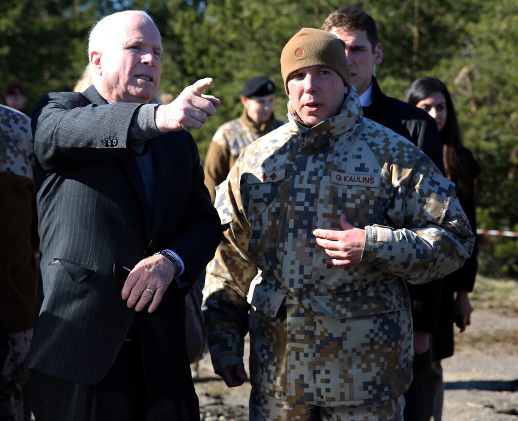 United States Senator John McCain (R-AZ) speaks with Latvian Lt. Col. Gunars Kaulins, the exercise director for Exercise Summer Shield about a live-fire exercise which involved U.S., Latvian, Estonian and Lithuanian service members at a range near Camp Adazi, Latvia, April 15, 2014. U.S. Marines with 3rd Battalion, 8th Marine Regiment, 2nd Marine Division assigned to Black Sea Rotational Force 14.2 are participating in Summer Shield in Latvia. This is the 11th iteration of the Summer Shield exercise, a joint staff planning and live-fire maneuver event designed to enhance the NATO force’s capacity and capability to integrate combined arms and maneuver at the battalion and brigade level. It also increases partner capacity, promotes regional stability, and enhances Latvian, Lithuanian, Estonian, and U.S. interoperability as NATO allies. (Official Marine Corps photo by Lance Cpl. Scott W. Whiting, BSRF PAO/ Released)