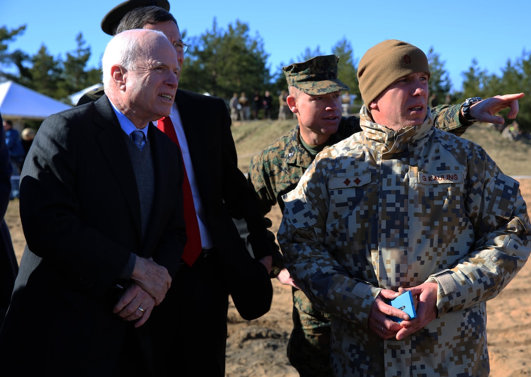 U.S. Marine Lt. Col. Trevor Hall, the battalion commander of 3rd Battalion, 8th Marine Regiment and Black Sea Rotational Force 14.2, points downrange at a target while speaking with Senators John McCain (R-AZ) and John Barrasso (R-WY), and Latvian Lt. Col. Gunars Kaulins, exercise director of Summer Shield, at a range near Camp Adazi, Latvia, April 15, 2014. This is the 11th iteration of the Summer Shield exercise, a joint staff planning and live-fire maneuver event designed to enhance the NATO force’s capacity and capability to integrate combined arms and maneuver at the battalion and brigade level. It also increases partner capacity, promotes regional stability, and enhances Latvian, Lithuanian, Estonian, and U.S. interoperability as NATO allies. (Official Marine Corps photo by Lance Cpl. Scott W. Whiting, BSRF PAO/ Released)