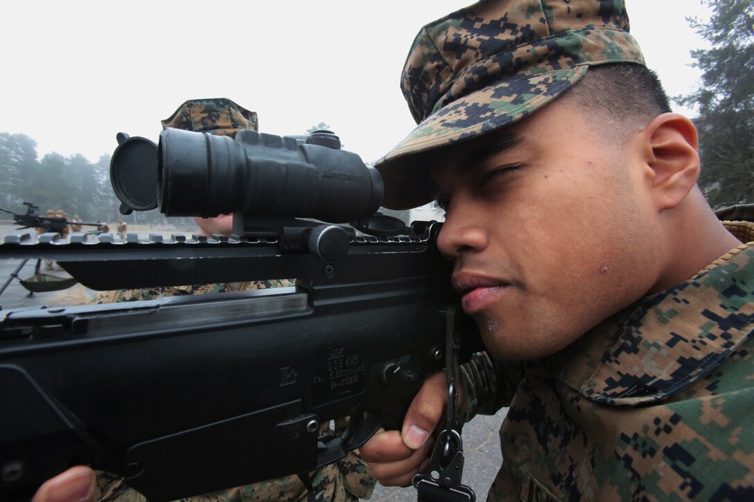 Lance Cpl. Junior Jack, machinegunner, Weapon’s Company, 3rd Battalion, 8th Marines, sights in on a Latvian G36 rifle at a weapon’s display during Summer Shield aboard Camp Adazi, Latvia, 7 April, 2014.  This is the 11th iteration of the Summer Shield exercise, a joint staff planning and combined arms live fire maneuver event designed to enhance the Latvian Land Force’s capacity and capability to integrate fires and maneuver at the battalion and brigade level as well as increase partner capacity, promote regional stability and to continue to develop Latvian, Lithuanian, Estonian and U.S. interoperability.  (Official Marine Corps photo by Staff Sgt. Tanner M. Iskra, 2nd Marine Division, BSRF, Combat Camera/Released)