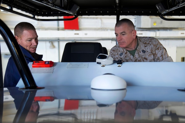 Marine Corps Sgt. Maj. Bryan B. Battaglia, right, senior enlisted advisor to the chairman of the Joint Chiefs of Staff, explores the instrument panel of the Midnight Express, a tactical training boat, which is part of Helicopter Interdiction Tactical Squadron, in Jacksonville, Fla., April 16, 2014.