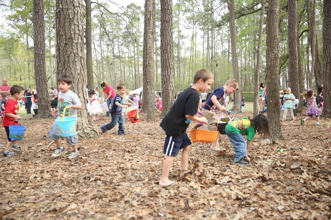 Children of service members with Marine Aircraft Group 14 search for Easter eggs during MAG-14’s Eggstravaganza at Marine Corps Air Station Cherry Point, N.C., April 11, 2014. MAG-14 holds an Easter event for the children every year. 