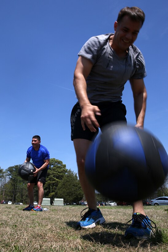 Staff Sgt. Shane A. Moody, a motor transportation chief with Marine Wing Support Squadron 274, performs medicine ball tosses during Marine Air Control Squadron 2’s first HITT for Heroes event at Marine Corps Air Station Cherry Point, N.C., April 11, 2014.