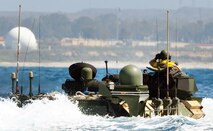For the testing of the Networking On-the-Move command-and-control system afloat, an Assault Amphibious Vehicle was configured as a point-of-presence amphibious vehicle, or "POP-V." Equipped with a wideband-Ku satellite communications system, the POP-V- shown approaching the beach at the Marine Corps Tactical Systems Support Activity at Camp Pendleton, Calif.-enables for the first time mission data and full-motion reconnaissance video from unmanned aerial vehicles to be distributed via secure wireless local networks. The data flows to commanders and staff aboard another amphibious staff vehicle as both vehicles operate on the move on land or at sea.