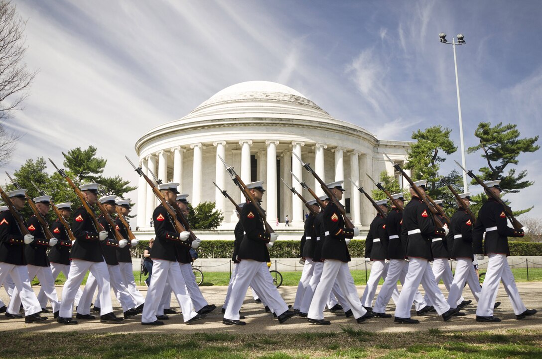The Marine Corps Silent Drill Platoon marches in front of the Thomas Jefferson Memorial on their way to perform for the Cherry Blossom Festival in Washington D.C., April 13, 2014. The Silent Drill Platoon travels across the country and the world showcasing close-order drill and the precision for which the Marine Corps is known. (U.S. Marine Corps photo by Sgt. Bryan Nygaard/Released)