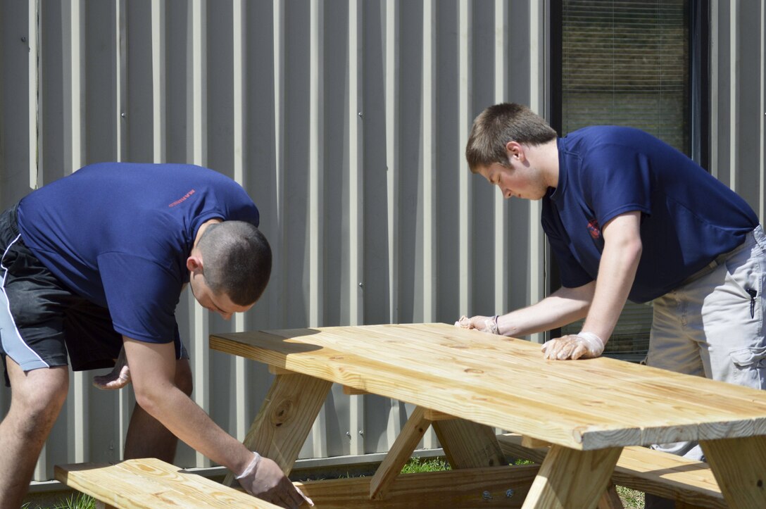 Poolees from Recruiting Sub-Station Glen Burnie finish a picnic table for the Providence Center in Arnold, Md., which provides care and services for adults with developmental disabilities, April 12, 2014. The picnic tables were one part of an event in honor of U.S. Marine Corps Lance Cpl. William T. Wild IV, a native of Severna, Md. who was killed during a training incident in Nevada March 18, 2013, and to improve the living situation for those that live at the Providence Center. The poolees are a part of the Marine Corps’ Delayed Entry Program where they are given a set amount of time to prepare before they are sent to Marine Corps Recruit Depot Parris Island, S.C. where they will try to earn the title of Marine. (U.S. Marine Corps photo by Sgt. Bryan Nygaard/Released)