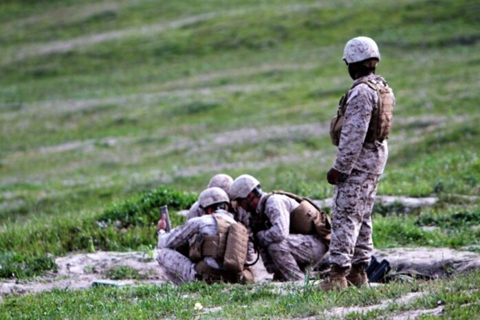 Marines with Weapons Company, 2nd Battalion, 7th Marine Regiment, prepare a 60 mm mortar to be fired during a mortar fire exercise aboard Marine Corps Base Camp Pendleton, Calif., April 4, 2014. The unit, based out of Marine Corps Air Ground Combat Center Twentynine Palms, Calif., came to Camp Pendleton to conduct training on the different types of terrain the base has to offer. The exercise tested the Marine’s ability to fire on unknown distance targets with 60 mm and 81 mm mortars. (U.S. Marine Corps photo by Lance Cpl. Joshua Murray/Released)