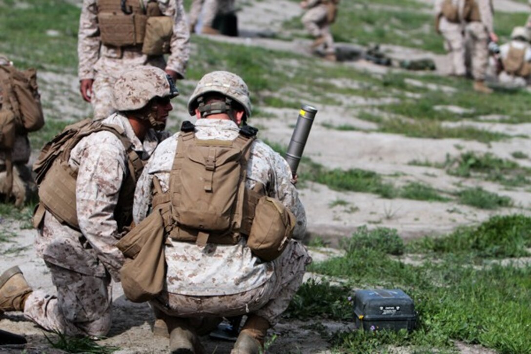 Marines with Weapons Company, 2nd Battalion, 7th Marine Regiment, prepare to fire 60 mm mortars during a mortar fire exercise aboard Marine Corps Base Camp Pendleton, Calif., April 4, 2014. The unit, based out of Marine Corps Air Ground Combat Center Twentynine Palms, Calif., came to Camp Pendleton to conduct training on the different types of terrain the base has to offer. The exercise tested the Marine’s ability to fire on unknown distance targets with 60 mm and 81 mm mortars. (U.S. Marine Corps photo by Lance Cpl. Joshua Murray/Released)